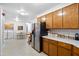 Bright kitchen featuring wood cabinetry, stainless steel appliances, and easy access to a dining area and laundry room at 617 Willdrew Ln, Moncks Corner, SC 29461