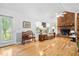 Bright living room with hardwood floors, brick fireplace, and plenty of natural light from the large window and glass door at 617 Willdrew Ln, Moncks Corner, SC 29461