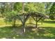 Wooden pergola in the backyard, surrounded by trees and greenery at 617 Willdrew Ln, Moncks Corner, SC 29461
