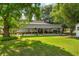 A lovely home with a large covered back porch overlooking a spacious green lawn and mature trees at 617 Willdrew Ln, Moncks Corner, SC 29461