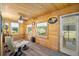 Relaxing sunroom featuring wood-paneled walls and ceiling, and a comfortable seating area by the windows at 617 Willdrew Ln, Moncks Corner, SC 29461
