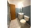 Bathroom with blue tiled walls, a white vanity, and a toilet at 6287 Sniders Hwy, Walterboro, SC 29488