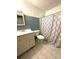Bathroom featuring blue tiled walls, a single vanity, and a shower with patterned curtain at 6287 Sniders Hwy, Walterboro, SC 29488