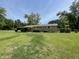 Single-story home with a covered porch, set on a large lot with mature trees at 6287 Sniders Hwy, Walterboro, SC 29488