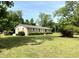 Charming single-story home with a brick facade, lush lawn, and mature trees at 6287 Sniders Hwy, Walterboro, SC 29488