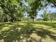 Picturesque front yard showcasing mature trees, open space, and an inviting exterior with outbuildings at 6287 Sniders Hwy, Walterboro, SC 29488