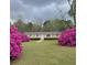 Charming home featuring vibrant pink azaleas flanking the entrance, set against a lush green lawn at 6287 Sniders Hwy, Walterboro, SC 29488