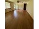 Spacious living area featuring wood-look floors, a ceiling fan, and a front door at 6287 Sniders Hwy, Walterboro, SC 29488