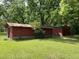 Backyard sheds surrounded by grassy lawn with trees and blue sky at 6287 Sniders Hwy, Walterboro, SC 29488