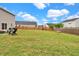 Spacious backyard featuring a lush lawn, wooden fence, and outdoor seating area at 716 Mcroy St, Moncks Corner, SC 29461