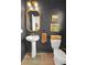 Stylish half-bathroom with dark walls, pedestal sink, and decorative accents, offers a modern and functional space at 716 Mcroy St, Moncks Corner, SC 29461