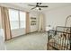 A bright neutral toned bedroom with a ceiling fan and crib at 716 Mcroy St, Moncks Corner, SC 29461