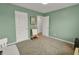 A neutral bedroom featuring carpet, light and doors at 716 Mcroy St, Moncks Corner, SC 29461