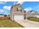Two-story home with a two-car garage, manicured lawn, and fresh landscaping at 716 Mcroy St, Moncks Corner, SC 29461