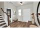 Inviting foyer with wood floors, a bench, and stairs leading to the upper level create a warm entrance at 716 Mcroy St, Moncks Corner, SC 29461
