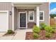 Inviting front porch with seating, attractive landscaping, and a stylish entrance at 716 Mcroy St, Moncks Corner, SC 29461