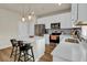 Well-lit kitchen featuring a kitchen island, stainless steel appliances, and ample counter space for meal preparation at 716 Mcroy St, Moncks Corner, SC 29461