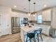 Modern kitchen with stainless steel appliances, white cabinets, and a quartz island offers a stylish cooking space at 716 Mcroy St, Moncks Corner, SC 29461