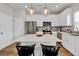 Bright, stylish kitchen with stainless steel appliances, a quartz island, and pendant lighting, offering a perfect culinary space at 716 Mcroy St, Moncks Corner, SC 29461