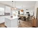 Bright, open kitchen with island, pendant lighting, and stainless appliances flows into the dining and living area at 716 Mcroy St, Moncks Corner, SC 29461