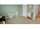 Inviting playroom featuring soft green walls, a small table and chairs, and space for learning and fun at 716 Mcroy St, Moncks Corner, SC 29461