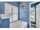 Bathtub with view outside, great light, calming blue walls, and modern fixtures at 7302 Sanderling Ct, Hanahan, SC 29410