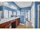 Bathroom with double sinks, vanity, toilet, separate tub, and all painted a bright inviting blue at 7302 Sanderling Ct, Hanahan, SC 29410