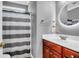 Bathroom with a stripe shower curtain, a wood vanity with a light up circular mirror, and gray walls at 7302 Sanderling Ct, Hanahan, SC 29410