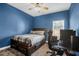 Bedroom with an accent wall, ceiling fan, bed, desk, and chair at 7302 Sanderling Ct, Hanahan, SC 29410