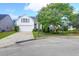 Attractive white home featuring a well-kept lawn, an attached garage, and a basketball hoop on the driveway at 7302 Sanderling Ct, Hanahan, SC 29410