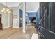 Elegant foyer showcasing hardwood floors, sophisticated lighting, and views into adjoining living spaces at 7302 Sanderling Ct, Hanahan, SC 29410