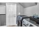 Gray laundry room featuring a new washer and dryer set with white door to the outside at 7302 Sanderling Ct, Hanahan, SC 29410