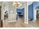 Open-concept living area showcasing hardwood floors, arched doorways, and a grand piano at 7302 Sanderling Ct, Hanahan, SC 29410