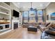 Bright and airy living room featuring a fireplace, built-in shelves, and a large sectional sofa at 7302 Sanderling Ct, Hanahan, SC 29410