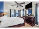Main bedroom with dresser, mirror, en-suite, ceiling fan, and filled with lots of light at 7302 Sanderling Ct, Hanahan, SC 29410
