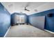 Bright and spacious media room features blue walls, carpeted floors, projector, screen and ceiling fan at 7302 Sanderling Ct, Hanahan, SC 29410