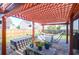 Outdoor pergola with pavers, lights, outdoor sofa and grill at 7302 Sanderling Ct, Hanahan, SC 29410