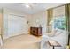 Bright bedroom featuring a comfy armchair, traditional dresser, and a large window with tree-filtered light at 734 Fort Sumter Dr, Charleston, SC 29412