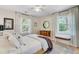 Bedroom showcasing a cozy crib, a dresser, and a large bed with ample natural light from windows at 734 Fort Sumter Dr, Charleston, SC 29412