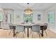 Dining room showcasing a rustic wood table, modern chairs, and a stylish wicker chandelier above a parquet wood floor at 734 Fort Sumter Dr, Charleston, SC 29412