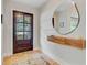 Stylish foyer featuring a modern floating shelf and a large round mirror next to a dark wooden door at 734 Fort Sumter Dr, Charleston, SC 29412
