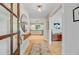 Inviting foyer with hardwood floors, decorative mirror and a glimpse of the kitchen, creating a welcoming entrance at 734 Fort Sumter Dr, Charleston, SC 29412