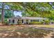 Beautiful home exterior featuring classic architectural details, mature trees, and manicured landscaping at 734 Fort Sumter Dr, Charleston, SC 29412
