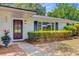 Charming white brick home with a well-manicured lawn and a dark wooden front door with glass panels at 734 Fort Sumter Dr, Charleston, SC 29412