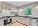 Modern kitchen with stainless steel appliances, white cabinets, and a large window offering plenty of natural light at 734 Fort Sumter Dr, Charleston, SC 29412