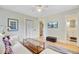 Cozy living room featuring stylish furnishings, a decorative trunk, and a view into the bright and modern bathroom at 734 Fort Sumter Dr, Charleston, SC 29412