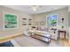Inviting living room features a plush sofa, large windows, and built-in shelving for a comfortable space at 734 Fort Sumter Dr, Charleston, SC 29412