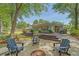 Inviting backyard featuring a spacious deck, fire pit with Adirondack chairs, and lush landscaping for outdoor relaxation at 803 Burnett Dr, Charleston, SC 29412