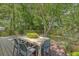 Wooden deck featuring a modern outdoor dining table amidst a lush, green backyard at 803 Burnett Dr, Charleston, SC 29412