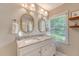 Bright bathroom with double vanity, decorative mirrors, and ample natural light at 803 Burnett Dr, Charleston, SC 29412